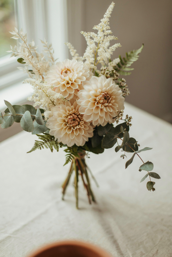 Soft, feathery bouquet of cream-colored dahlias mixed with ivory astilbe plumes and pale greenery