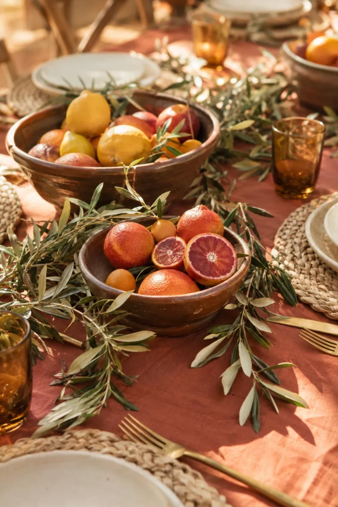 Brown ceramic bowls with citrus and olive branches on woven placemats