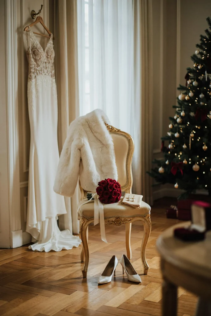 Bride wearing a white faux fur stole with a red rose bouquet
