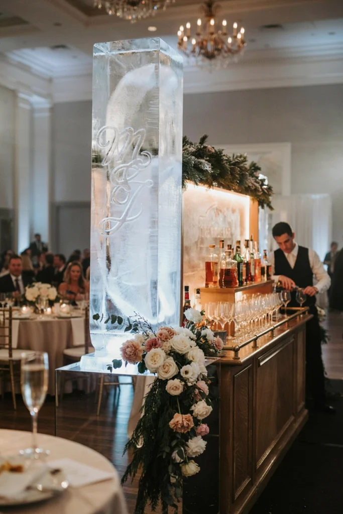 Illuminated monogram ice sculpture on a mirrored base