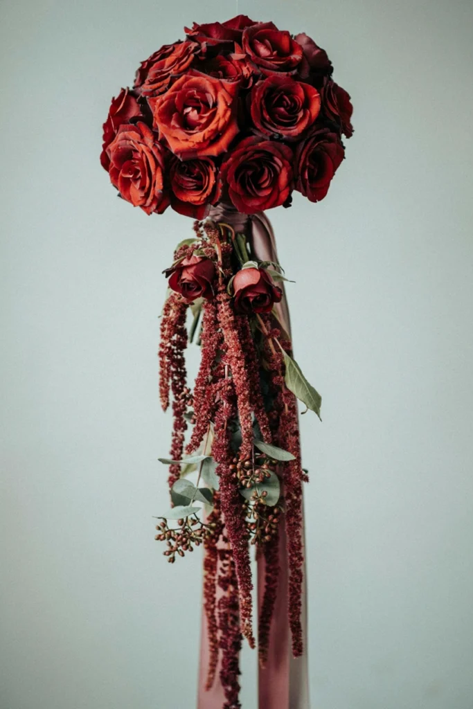 Romantic cascading-style bouquet of burgundy roses with long, flowing deep burgundy amaranthus strands