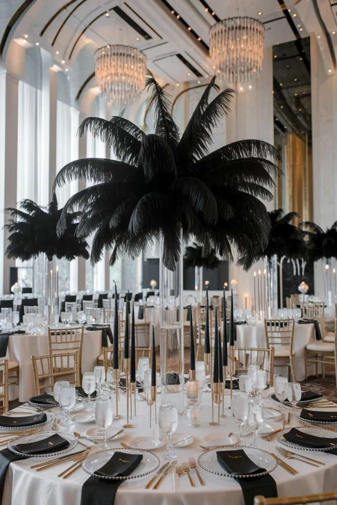 Long banquet table with tall black feather centerpieces, black taper candles, and gold flatware