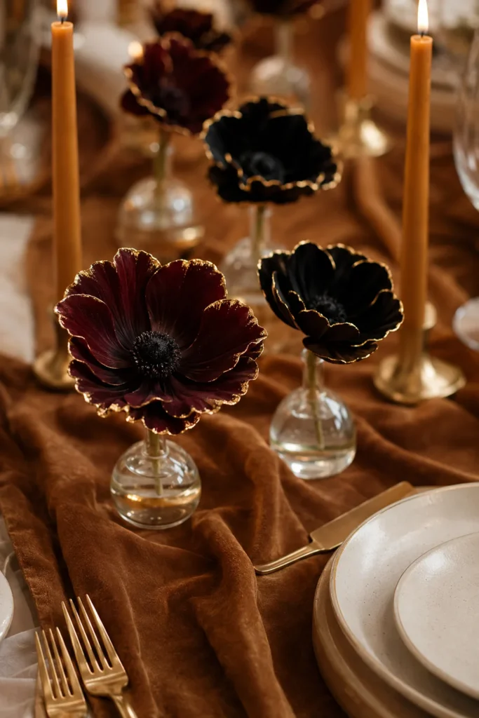 Suede table runner with gold-dipped anemones and honey candles