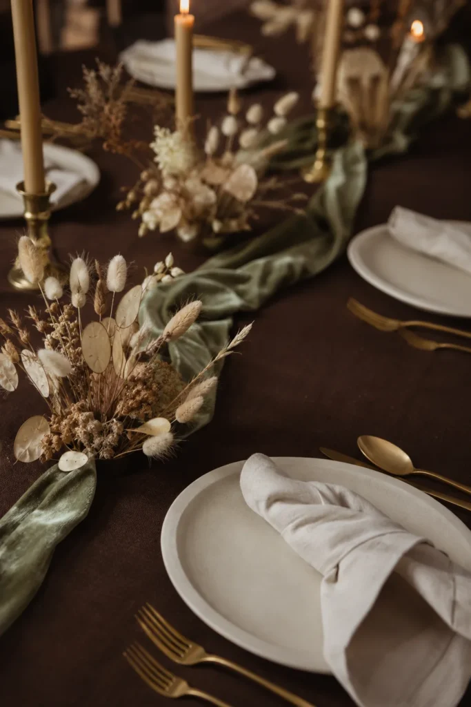 Espresso brown table with sage velvet ribbon and dried botanicals