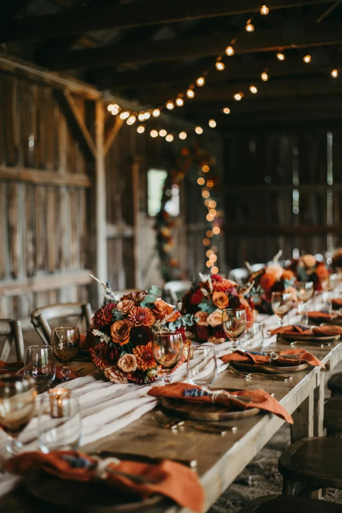 Sage twig and autumn branch centerpiece on a fall wedding table