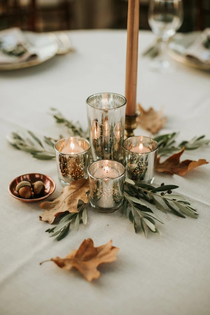 Cluster of copper and bronze mercury glass candle holders on a wedding reception table