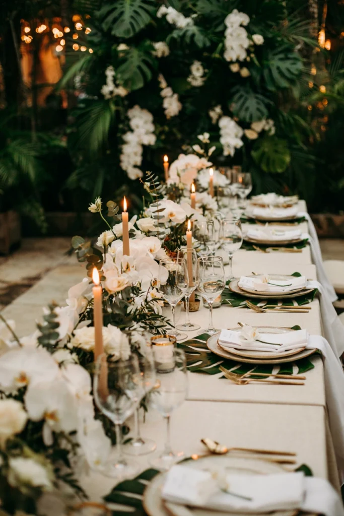 Monstera leaf place setting with a white orchid stem for a modern wedding table