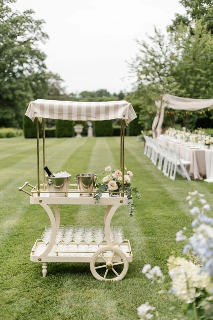Vintage cream champagne cart at outdoor wedding reception