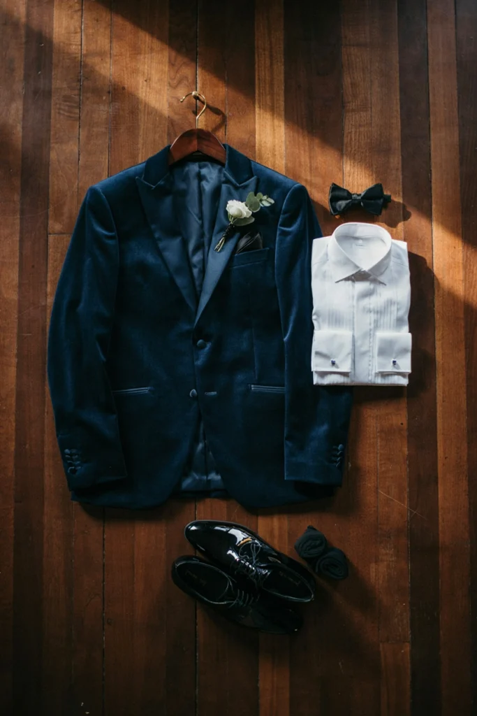 Groom wearing a French blue velvet dinner jacket at an evening wedding reception