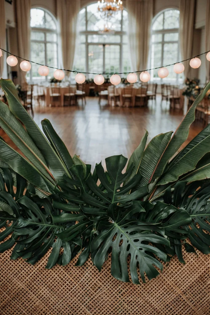 Monstera and banana leaf backdrop for a tropical small wedding photobooth