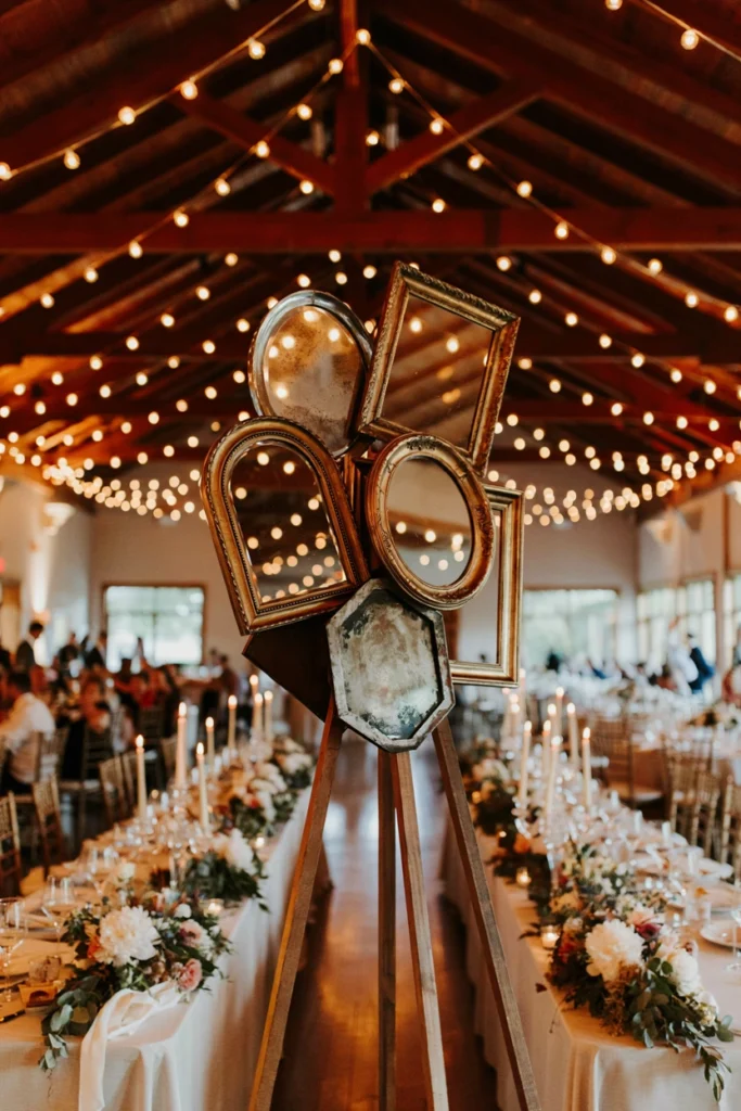 Cluster of vintage mirrors reflecting string lights at a small wedding photobooth