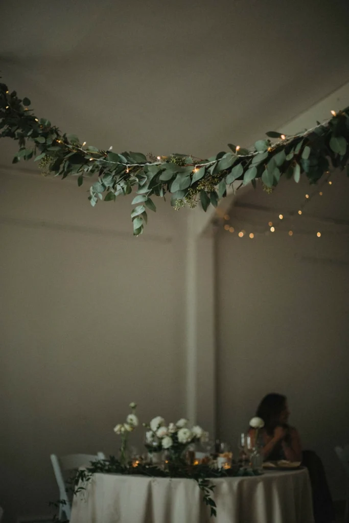 Eucalyptus garland and fairy lights in a cozy small wedding photobooth nook