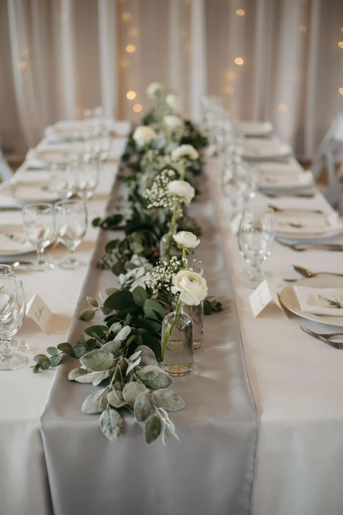 Frosted eucalyptus garland on a silver winter wedding table runner