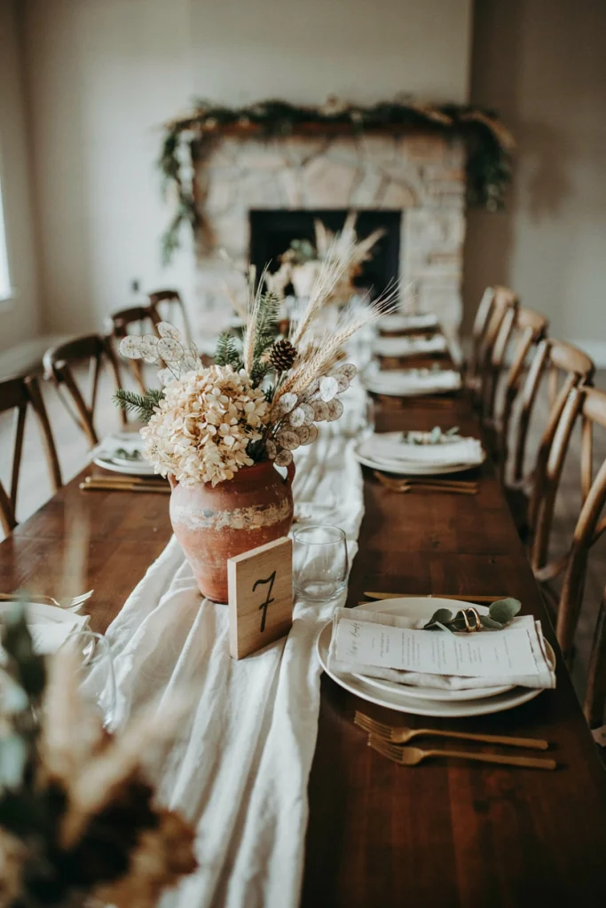 Dried hydrangea and wheat centerpiece in a terracotta vase