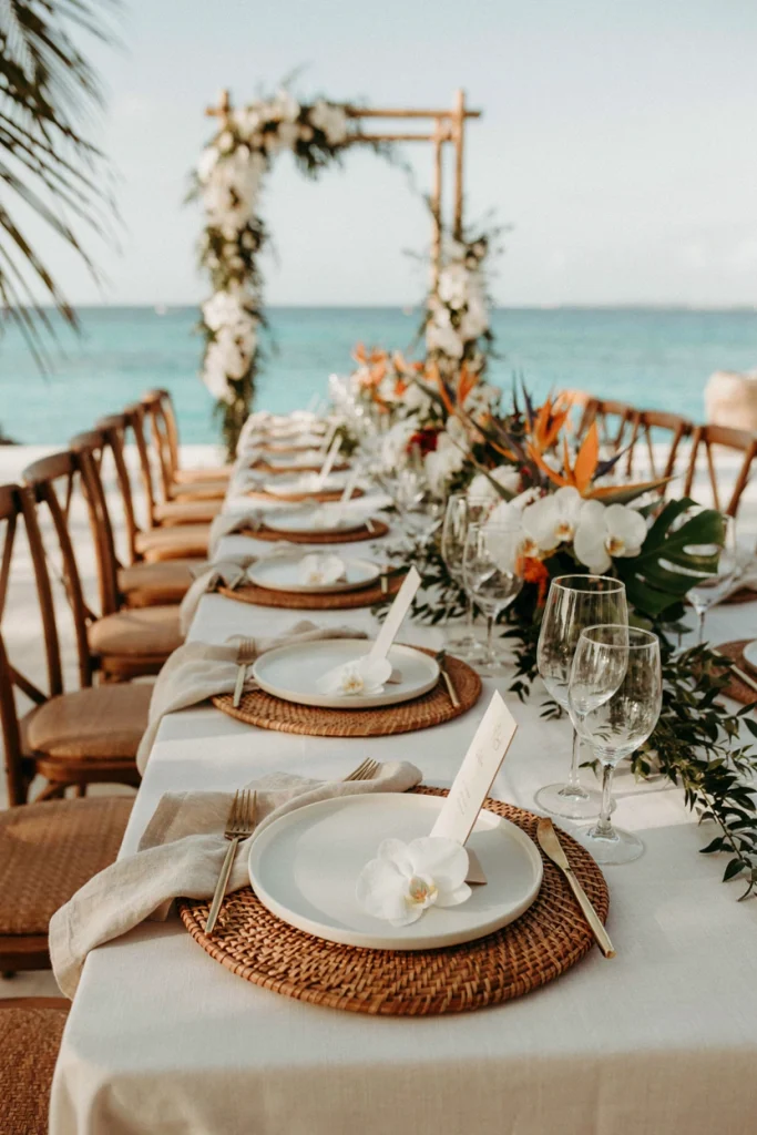 Woven bamboo chargers with natural linen napkins at a beachside table