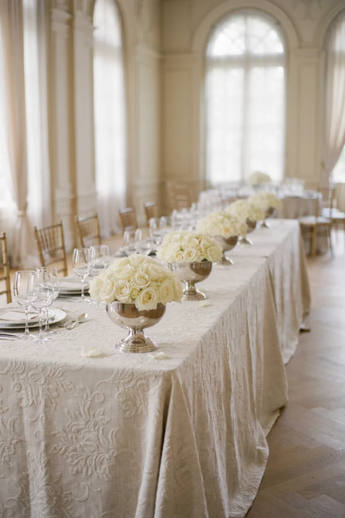 Ivory damask linen tablecloth with silver candlesticks and votives