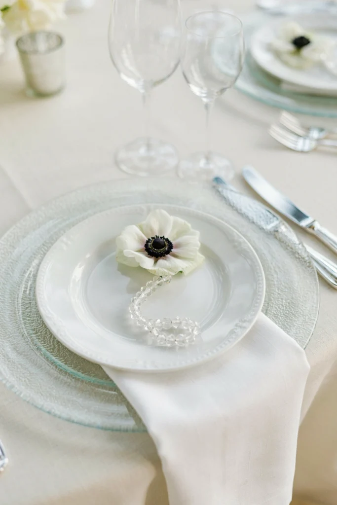 Close up of a frosted glass charger plate with a crystal beaded napkin ring
