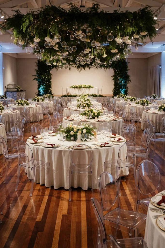 White and green tablescape with pine sprigs and glass ornament accents