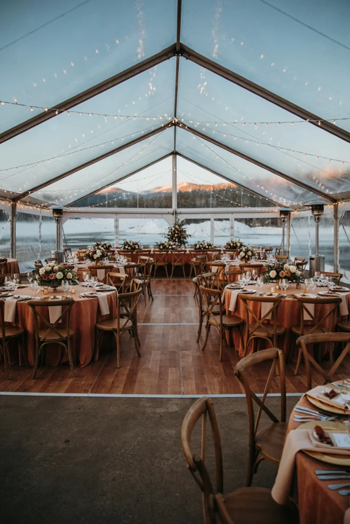 Golden hour outdoor ceremony with a snowy backdrop and warm amber lighting
