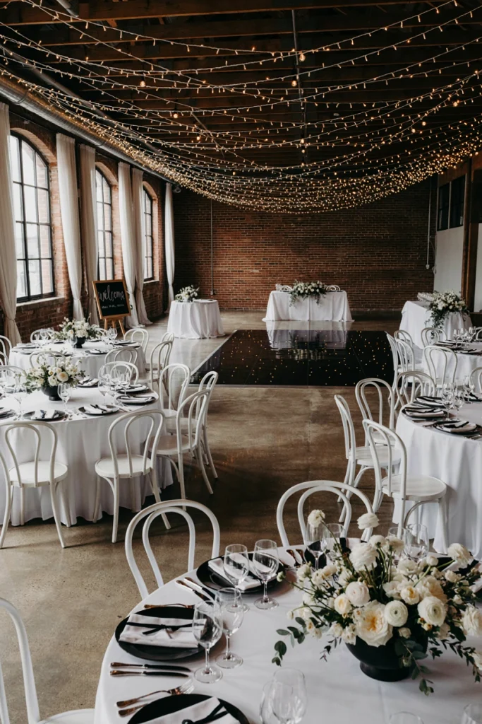 Black and white reception with fairy lights strung like falling snow